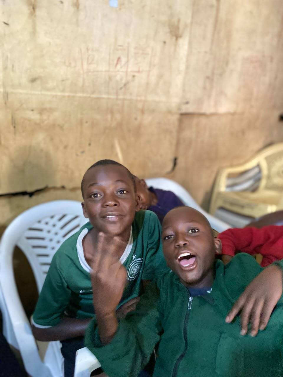 Volunteer handing school supplies to a child