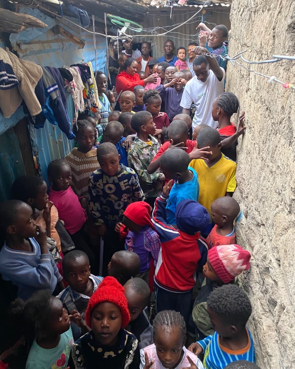 Volunteers spending time with children during a community visit