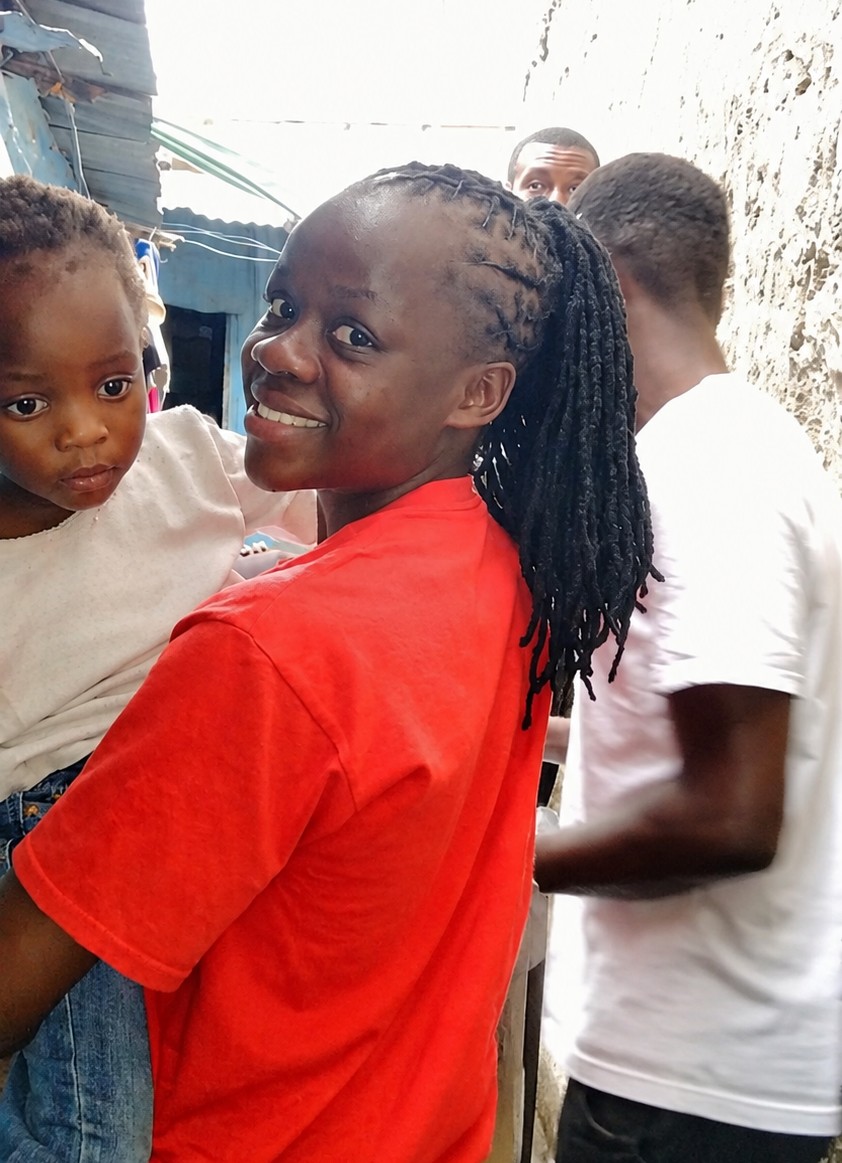 Volunteer listening to a child during a home visit